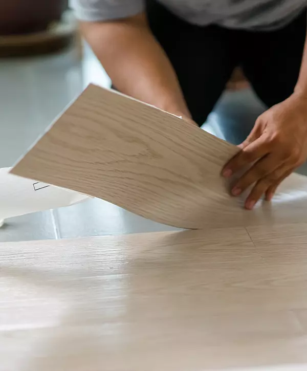 The Best Vinyl Flooring Installation In Riverbank, CA A person installing new vinyl tile floor