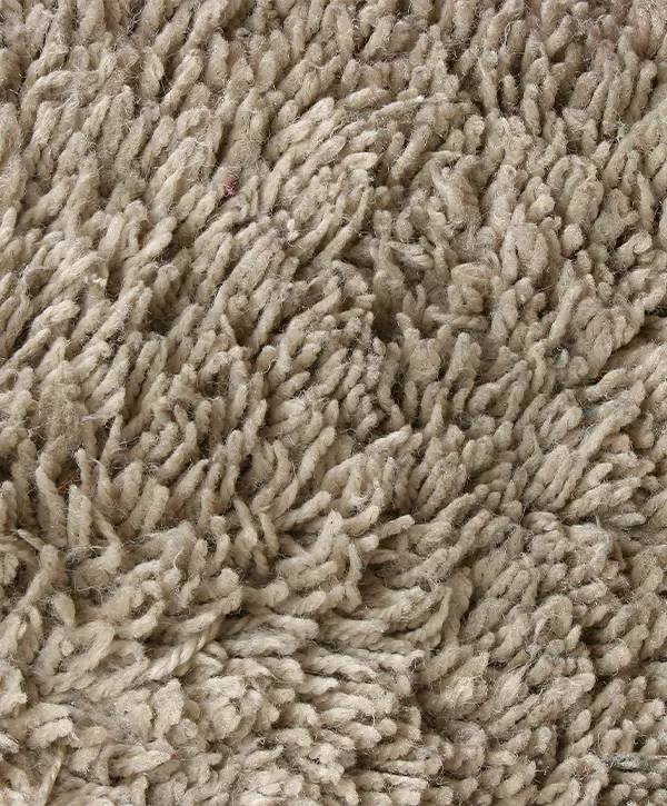 extreme close up of a cream brown plush carpet