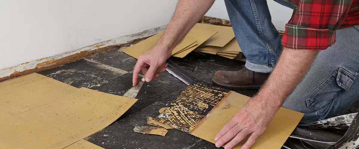 Old vinyl tiles removal from floor in a room or kitchen